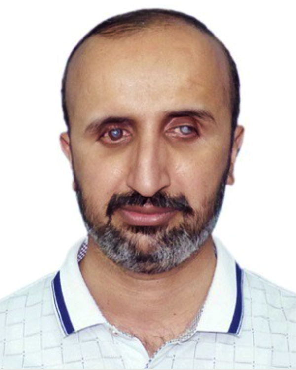 Headshot of Dr. Shabbir Awan in a blue and white polo shirt, with groomed black and grey facial hair